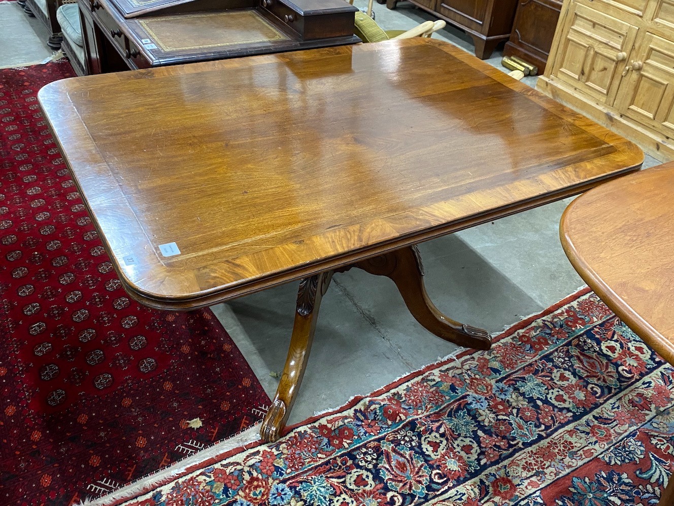 A Regency banded mahogany rectangular tilt top dining table, length 141cm, depth 106cm, height 75cm